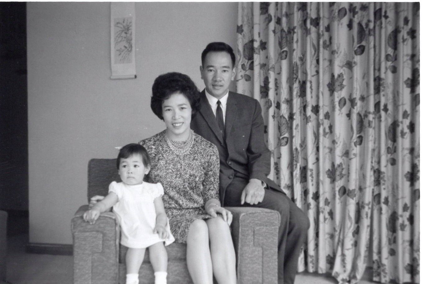 1965 Black and White photo of 18 month Carole sitting with her parents Nellie, and Warren having arrived in South Bend, Indiana.