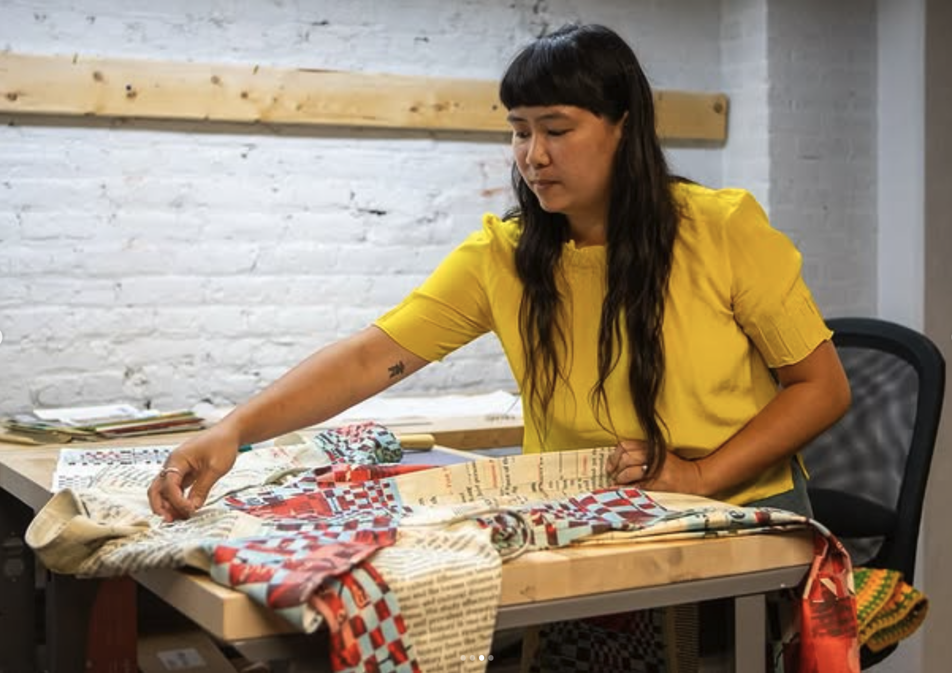 Daughter and artist Elena dressed in a bright yellow shirt working on her dust jacket duster jacket